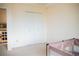 Bright bedroom with a closet and a playpen in the corner at 7961 Jared Way, Littleton, CO 80125