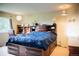 Comfortable bedroom with large bed, built-in bookcase headboard, and functional desk space at 7961 Jared Way, Littleton, CO 80125