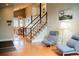 Inviting entryway featuring beautiful hardwood floors, staircase, and lots of natural light at 7961 Jared Way, Littleton, CO 80125