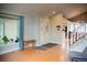 Welcoming foyer with front door, hardwood floors, and adjacent staircase to upper level at 7961 Jared Way, Littleton, CO 80125
