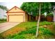 Charming home featuring a manicured lawn, mature trees and a two car garage at 7961 Jared Way, Littleton, CO 80125