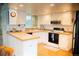 Well-lit kitchen features butcher block countertops, white cabinets, and modern appliances at 7961 Jared Way, Littleton, CO 80125