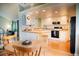 Bright kitchen with white cabinetry, butcher block countertops and black appliances at 7961 Jared Way, Littleton, CO 80125