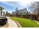 Fenced backyard features a lush lawn area, walkway, and patio perfect for outdoor entertaining and relaxation at 4950 Mt Cameron Dr, Brighton, CO 80601