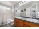 Bright bathroom with a double sink vanity, tub with shower and nautical accents at 4950 Mt Cameron Dr, Brighton, CO 80601