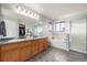 Bathroom featuring double sinks, a soaking tub, and a glass shower at 4950 Mt Cameron Dr, Brighton, CO 80601