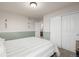 This bedroom features green and white walls, carpeted floors, and access to an ensuite at 4950 Mt Cameron Dr, Brighton, CO 80601
