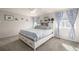 Comfortable bedroom featuring a king-sized bed with storage and large windows at 4950 Mt Cameron Dr, Brighton, CO 80601