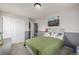 Comfortable bedroom with a gray accent wall, plush carpet, and natural light at 4950 Mt Cameron Dr, Brighton, CO 80601