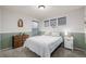 This bedroom has a queen-sized bed and carpeted floors and three windows at 4950 Mt Cameron Dr, Brighton, CO 80601