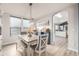 Bright dining room with a modern chandelier and a stylish table with upholstered chairs and bench seating at 4950 Mt Cameron Dr, Brighton, CO 80601