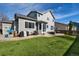 The home's exterior shows a well-manicured lawn, patio, and neat siding under a sunny sky at 4950 Mt Cameron Dr, Brighton, CO 80601