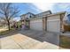 Charming two-story home with a three-car garage, stone accents, and well-maintained landscaping at 4950 Mt Cameron Dr, Brighton, CO 80601