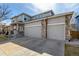 Charming two-story home features a three-car garage, inviting porch, and stone pillar accents at 4950 Mt Cameron Dr, Brighton, CO 80601