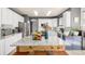 Bright kitchen with white cabinets, stainless appliances, and a large granite-topped island with seating at 4950 Mt Cameron Dr, Brighton, CO 80601