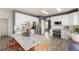 Well-lit kitchen with white cabinetry, stainless appliances, and a large granite-topped island with seating at 4950 Mt Cameron Dr, Brighton, CO 80601
