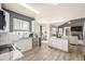 Bright, open kitchen featuring white cabinets, stainless steel appliances, and a center island at 4950 Mt Cameron Dr, Brighton, CO 80601