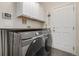 Efficient laundry room with modern appliances and storage cabinets for organization at 4950 Mt Cameron Dr, Brighton, CO 80601