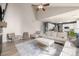 Bright living room with light wood floors, modern fireplace, comfortable seating, and adjacent kitchen at 4950 Mt Cameron Dr, Brighton, CO 80601