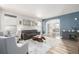 Spacious living room with modern decor, large windows, comfortable seating and stylish area rug at 4950 Mt Cameron Dr, Brighton, CO 80601