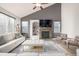 Inviting living room with vaulted ceilings, modern fireplace, comfortable seating, and ample natural light at 4950 Mt Cameron Dr, Brighton, CO 80601