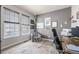 Cozy office with a large window and a patterned accent chair at 4950 Mt Cameron Dr, Brighton, CO 80601