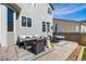 Outdoor patio features a wicker seating arrangement, heater, table, and an umbrella for relaxing in the backyard at 4950 Mt Cameron Dr, Brighton, CO 80601