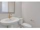 Bathroom features a pedestal sink and a modern elongated toilet at 16778 W 93Rd Pl, Arvada, CO 80007