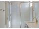 This bathroom features an enclosed glass shower, quartz countertop, and gold fixtures at 16778 W 93Rd Pl, Arvada, CO 80007