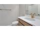 This bathroom features a large mirror, gold fixtures, a white sink, and white tile in shower at 16778 W 93Rd Pl, Arvada, CO 80007