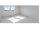 Well-lit bedroom with neutral carpet and a dual window offering ample natural light at 16778 W 93Rd Pl, Arvada, CO 80007