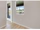 An empty room with a large window and door to an outdoor patio at 16778 W 93Rd Pl, Arvada, CO 80007