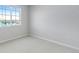 This bedroom features neutral walls and carpet, and a large window providing natural light at 16778 W 93Rd Pl, Arvada, CO 80007