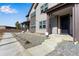 Inviting townhome with a modern exterior, neat landscaping, and a charming entrance with gray stone at 16778 W 93Rd Pl, Arvada, CO 80007