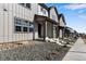 Charming home exterior showcasing neutral siding, covered entryway, and low maintenance landscaping at 16778 W 93Rd Pl, Arvada, CO 80007