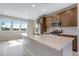 Chic kitchen featuring stainless steel appliances, stylish cabinetry, and an island with quartz countertops at 16778 W 93Rd Pl, Arvada, CO 80007