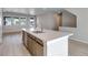 Spacious kitchen with large island, modern wood floors, and bright natural light at 16778 W 93Rd Pl, Arvada, CO 80007