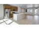 Gourmet kitchen with a central island, stainless steel appliances, and sleek light wood flooring at 16778 W 93Rd Pl, Arvada, CO 80007