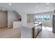 Open-concept kitchen featuring a large island, stainless steel appliances, and modern finishes at 16778 W 93Rd Pl, Arvada, CO 80007