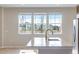 Modern kitchen island features stainless steel appliances and a golden faucet with exterior window views at 16778 W 93Rd Pl, Arvada, CO 80007