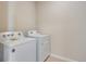 Laundry room featuring a full size washer and dryer with white appliances and light wood flooring at 16778 W 93Rd Pl, Arvada, CO 80007