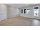 Spacious living room with wood floors, bright windows and a door to the outside patio at 16778 W 93Rd Pl, Arvada, CO 80007