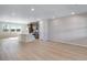 Bright, open-concept living room featuring wood floors and an eat-in kitchen with stainless steel appliances at 16778 W 93Rd Pl, Arvada, CO 80007