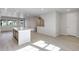 Open living space featuring modern light wood floors, large windows, and easy access to the kitchen at 16778 W 93Rd Pl, Arvada, CO 80007