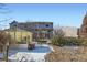 View of the back of the home and backyard with deck and partial landscaping at 4666 Cornish Way, Denver, CO 80239