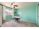 Bright bedroom with light teal walls, carpet, desk, and modern ceiling fan at 4666 Cornish Way, Denver, CO 80239