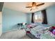 Light blue bedroom featuring carpet, a ceiling fan, and a study desk at 4666 Cornish Way, Denver, CO 80239