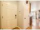Clean entryway showcasing the front door and a glimpse into the living area with wood flooring at 4666 Cornish Way, Denver, CO 80239