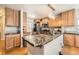 Open kitchen with stainless appliances, a kitchen island, and wooden cabinets at 4666 Cornish Way, Denver, CO 80239