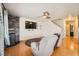 Living room with hardwood floors, fan, fireplace, and a large tv at 4666 Cornish Way, Denver, CO 80239